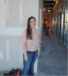 Doctor at building of new clinic